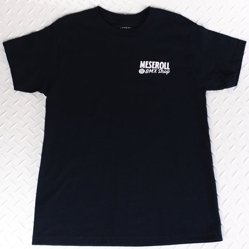Black t-shirt with a logo on a white textured background